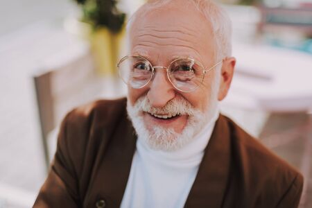 Close up portrait of stylish happy old manの写真素材