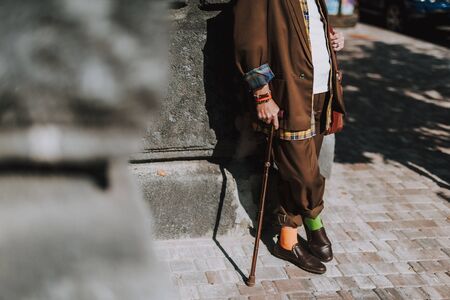 Stylish senior man leaning against the wallの写真素材