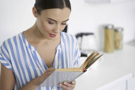 Curious young reader with interesting book stock photoの写真素材