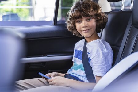 Happy kid is seating the belt and posing for camera