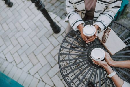 Woman hands with paper cups of coffeeの写真素材