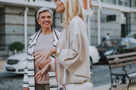 Two beautiful stylish Caucasian women talking outdoors