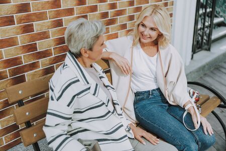 Cheerful pretty woman looking at a friendの写真素材