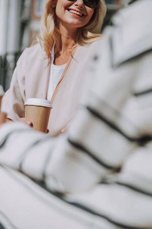 Lady in sunglasses looking at her friendの写真素材