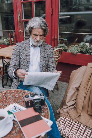 Reading interesting article in newspaper stock photoの写真素材