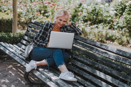 Woman in casual wear using her computerの写真素材