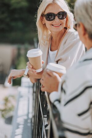Joyful Caucasian woman talking to her friendの写真素材