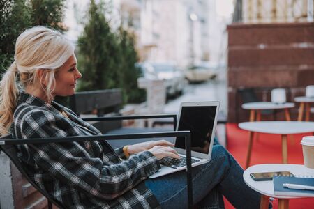 Woman working on a laptop in a cafeの写真素材