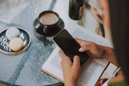 Young woman is typing om mobile phone