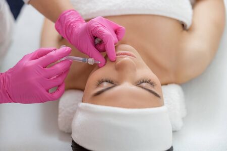 Close up of young woman getting beauty injection at sap salon stock photoの写真素材