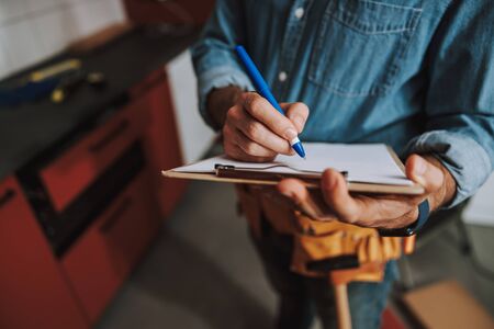 Making notes at repair workの写真素材