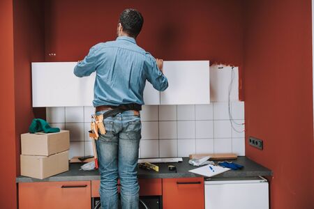 Back view of handyman working with tools stock photoの写真素材