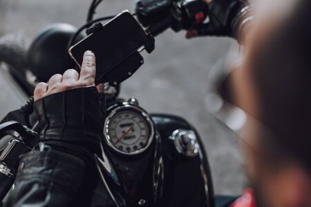 Caucasian motorcyclist using smartphone for navigation stock photoの写真素材