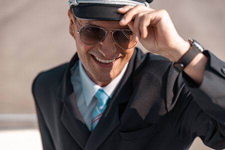 Close up of adult pilot in uniform posing for camera stock photo. Airway conceptの写真素材