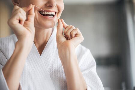 Close up of female hands that holding dental floss