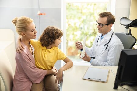 Female with son visiting pediatrist stock photoの写真素材