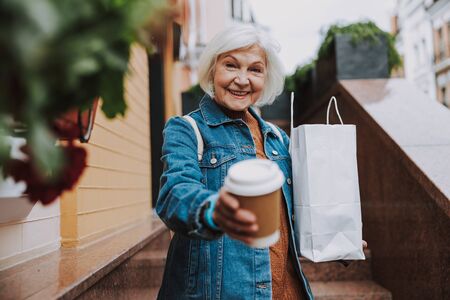Caucasian old lady having rest in cityの写真素材