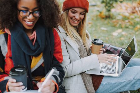 Two young girls spending day together in parkの写真素材