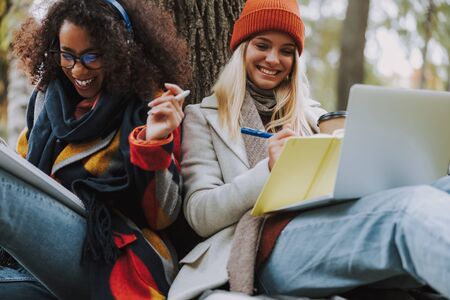 Pretty young girls spending day together in park