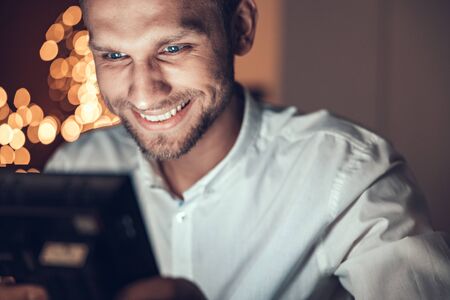 Close up of happy young man enjoying the evening