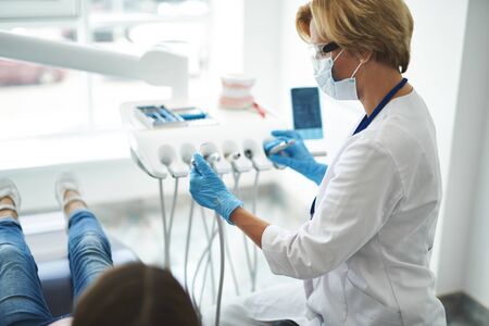 Pleasant female dentist going to have an examinationの写真素材