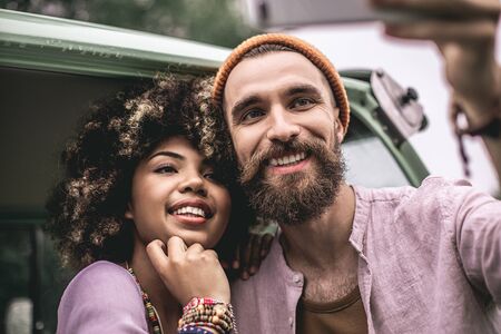 Cheerful hipster male and female lover make selfieの写真素材