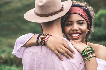 Happy beloved ethnicity man and woman embracingの写真素材