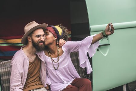 Hippie beloved couple making selfie in retro vanの写真素材