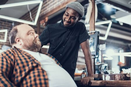 Client and hairstylist meeting in barber shopの写真素材