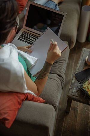 Young lady is holding notebook at home
