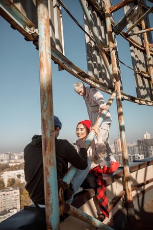 Happy pretty girl looking at her boyfriend on roofの写真素材