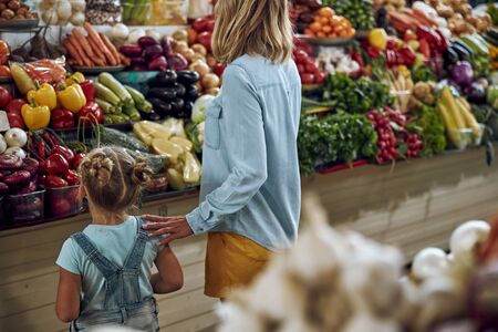 Choosing vegetables at the marketの写真素材