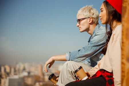Young friends is looking in front of themon roofの写真素材