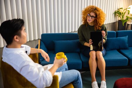 Young woman is holding tablet in handsの写真素材