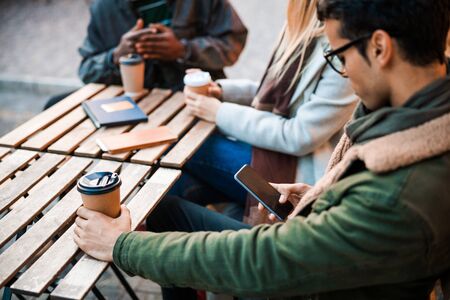 Young guy using mobile phone in cafe