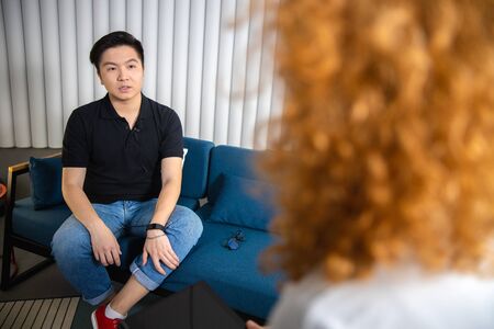 Man being questioned by woman stock photo