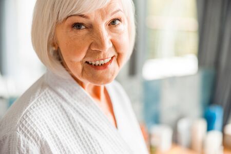 Joyful elderly woman looking at camera and smilingの写真素材