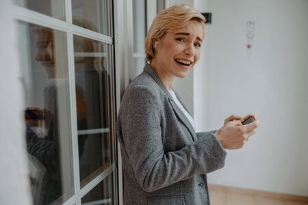 Happy young woman enjoying the game on smartphone