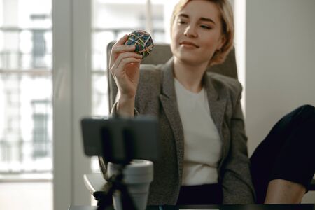 Smiling young lady resting while sitting in the office