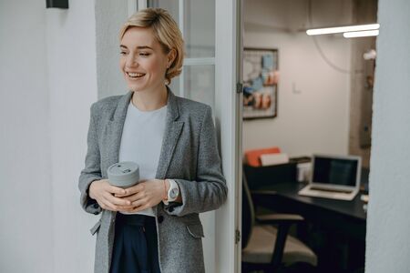 Happy young woman is resting with coffee
