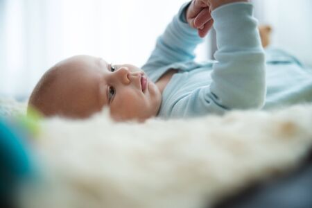Lovely baby playing with his fingers