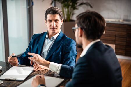 Focused calm man looking at his coworker