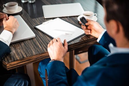 Cropped photo of two business partners sitting at the desk