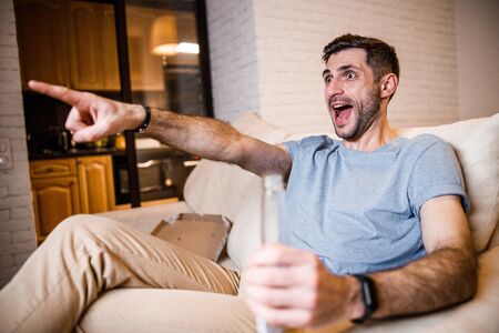 Young bachelor relaxing at home stock photoの写真素材