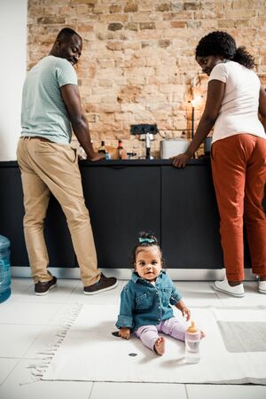 Happy parents looking at cute newborn daughter and smilingの写真素材