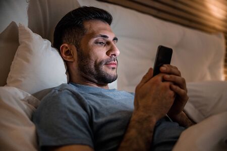 Man surfing internet at night stock photo