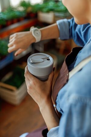 Caucasian florist looking at her wrist watchの写真素材
