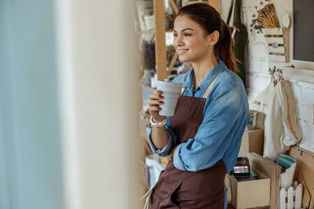 Female having a coffee break at workの写真素材