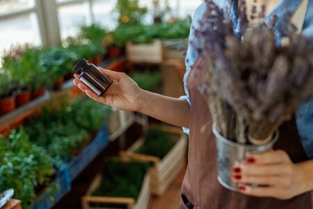 Woman with a vial of lavender essential oilの写真素材