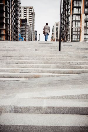 Stylish modern Caucasian male ascending the stepsの写真素材